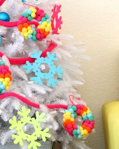 Colorful white christmas tree with knit garland